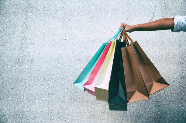 hand holding a number of shopping bags